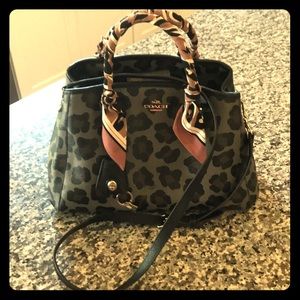 A brand new crossbody Coach leopard print purse.